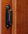 Half Inch Overlay Matte Black Cabinet Hinges Self Closing mounted on a wooden cabinet door in kitchen or bath.