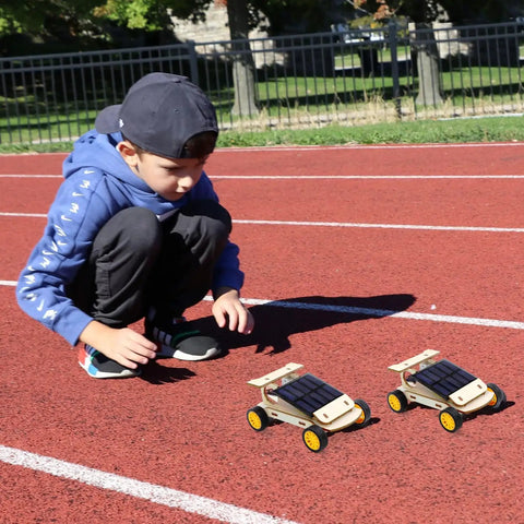 Child playing with DIY RC Car Kit Build Your Own Solar Powered Remote Control Car STEM Toys For Kids Ages 8 To 12 on track
