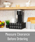 Two Drawer Coffee Pod Organizer With Removable Dividers Fits Up To 72 Pods Or Mix Of Pods And Office Essentials, Metal Mesh Coffee Station Base With Guided Drawer Track For Smooth Opening, Black Finish under a kitchen shelf with coffee maker on top