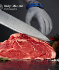 ANSI A9 Cut Resistant Stainless Steel Mesh Glove For Kitchen Use Pro Chef Grade Safety Food Grade Shield For Mandoline Slicing Meat Cutting Oyster Shucking Large Size Heavy Duty Protection shown slicing raw meat with a knife.