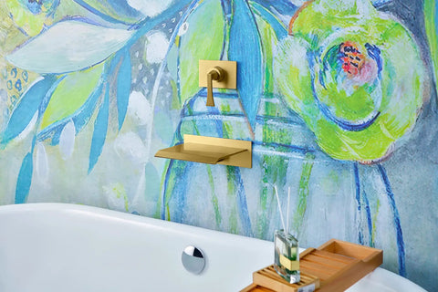 High Flow Wall Mount Tub Filler With Single Lever Large Waterfall Spout CUPC Certified Pressure Balance Rough In Valve Included Brushed Gold Finish Modern Bath Upgrade For Spa Vibes And A Handy Shelf For iPad Candles Or Glassware in bathroom setting