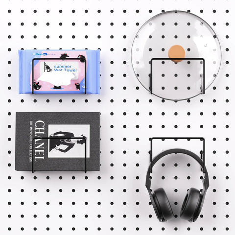 Slick Shop Pegboard Organizer And Hook Lock Kit With Heavy Duty Storage Bins displaying headphones, book, and wet towel on a pegboard.