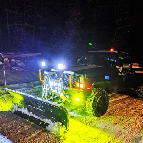 Amber 2-Pack 5-Inch Dual-Row LED Flood Lights 72W 10800 Lumens Off Road Driving Fog Light Bar on a truck with snowplow, night scene.
