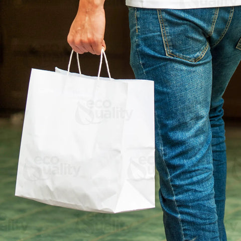 Person holding large white kraft paper bags with handles 13x7x17 inches 200 count durable reusable shopping gift bags go to party retail merchandise lunch and grocery use eco friendly packaging.