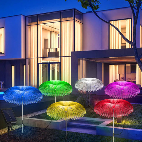 Solar Jellyfish Garden Lights 6 Pack Waterproof Outdoor Pathway Lawn Decor With 7 Color Changing Optical Fiber Bodies glowing in a yard
