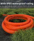 Heavy Duty Outdoor Extension Cord 100 Ft With Lighted End, 12/3 Gauge SJTW, Waterproof Cold-Resistant 3 Prong, orange in wet grass
