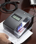 Big Win Digital Time Clock And Date Stamp Combo For Small Business Managers Keep Your Crew On Point With An Easy Punch Card System Including Fifty Time Cards Ink Ribbon And Backup Keys For Smooth Sailing on a desk, showing use with paperwork.