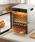 Premium Electric Food Dehydrator With Slick Dual Fan Heating On 12 Heavy Duty Stainless Steel Trays displaying dried fruit and herbs.