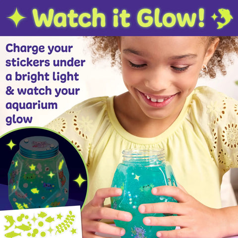 Totally Glowing Axolotl Aquarium Craft Kit For Kids Ages 6 And Up With Five Mini Axolotls, Glow In The Dark Decor, And STEM Fun, Hands On Arts And Science Gift For Girls And Boys; girl holds glow aquarium jar