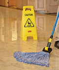26 Inch Heavy Duty Yellow Caution Sign For Slip Hazards And Wet Floors Twin Sided High Visibility Standup Floor Sign next to a mop on polished floor.