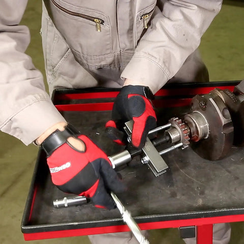 Mechanic using Five Inch Timing Gear And Pulley Puller For Removing Timing Gears And Pulleys With Tapped Holes on engine part