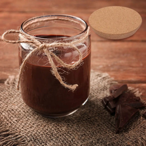 Big Tapered Cork Stoppers For 3.74 To 4.0 Inch Jar Openings next to a glass jar with a twine wrap on burlap mat