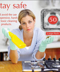 Woman with gloves holding a spray bottle near a gas stove with 50 Pack Disposable Gas Burner Liners For No Scrub Cleanup And Easy Stove Upkeep Aluminum Foil Square Covers That Protect The Burners Catch Grease And Spills Eight Point Five By Eight Point Five Inch Aluminum Foil Liners For Gas Stoves displayed.