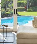 Patio view with modern living room, showcasing 4 Pack Adhesive Cabinet Handles Peel and Stick Black Pull Handles on sliding doors.