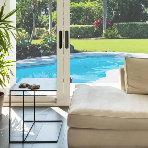 Patio view with modern living room, showcasing 4 Pack Adhesive Cabinet Handles Peel and Stick Black Pull Handles on sliding doors.