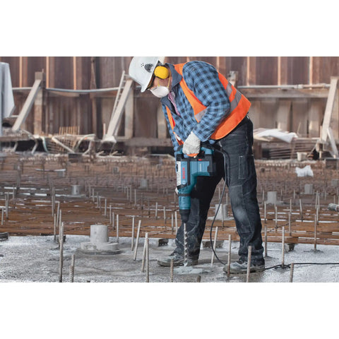 Worker using Beast SDS Max Rotary Hammer Bit One And Three Quarter Inch By Twenty Inch for concrete drilling on construction site