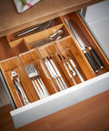 8 Pack Deep Drawer Organizers For Kitchens Closets And Bathrooms Super Solid Storage Bins with kitchen utensils neatly sorted.