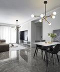 Sputnik Chandelier Pendant Light Black And Gold, Mid Century Modern E26 Ceiling Fixture in a modern living and dining area.