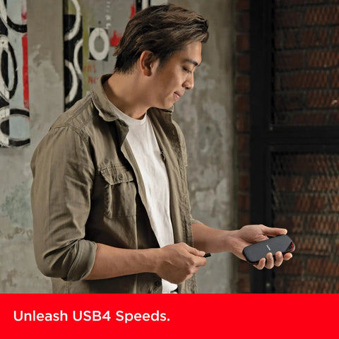 Person holding 4TB Extreme Pro Portable SSD With USB4 Speeds Up To 3800 MBps Read And 3700 MBps Write in hand close-up view
