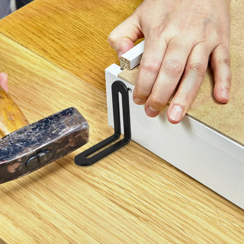 Installing Beefy Heavy Duty L Shaped Corner Brackets 10 Pcs Set For Shelves And Cabinets with hammer, black finish, in use