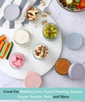 Top view of Six Pack 2.7 Oz Glass Salad Dressing Containers With Lids Leakproof Dipping Sauce Cups For Lunch Or Work Or Travel Reusable Small Condiment Jars BPA Free Dishwasher Safe Grab And Go Storage filled with various foods.