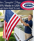 Made In USA Heavy Duty 3x5 Outdoor Flag, 100 Percent Nylon With Embroidered Stars And Sewn Stripes, displayed outside on a porch
