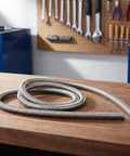 Heavy Duty Flexible Stainless Steel Electrical Wiring Conduit coiled on a wooden table, showcasing its smooth burr free bore.