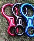 Red, black, and blue 35 kN Figure 8 Descender Rigging Plate for Rappelling on grass