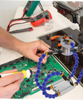 Multifunction Soldering Station And Welding Table Stand With Arms And Base Portable Helping Hands Tool in use on PCB