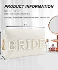 Bride Patch Makeup Bag With White Pearl Rhinestones For Women, Travel Toiletry Pouch on tabletop next to mirror and perfumes