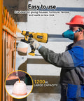 ProGrade 700W Airless Paint Sprayer And Hvlp Spray Gun With Four Swappable Tips And Three Pattern Options Including Integrated Blower And 1200Ml Cup in use, painting a fence.