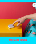 Person using Portable Smart Button Wireless Light Switch With App Control Battery Powered 50 Foot Range One Tap To Turn Lights On, Off, And Dim Includes 2 AAA Batteries Perfect For Home Automation on yellow table