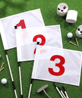 Six Foot Golf Flag Stick Set With Three Complete Flag Cup Kits And Numbered Nylon Flags 1, 2, 3 on artificial grass