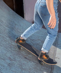 Skateboarder riding on ramp with Grip Tape For Skateboards, Longboards And Scooters - Non Slip, Bubble Free Application, 110 X 27 Cm
