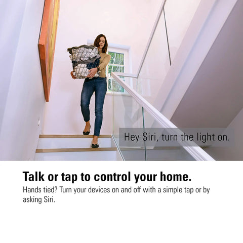 Woman carrying laundry up stairs using Apple HomeKit Smart Plug With Built-In Schedules And Power Meter for Siri voice control