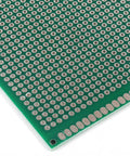 Close-up of a green double-sided PCB from the 20 Piece Double Sided PCB Prototype Kit For DIY Projects Four Sizes Includes Five Boards Per Size