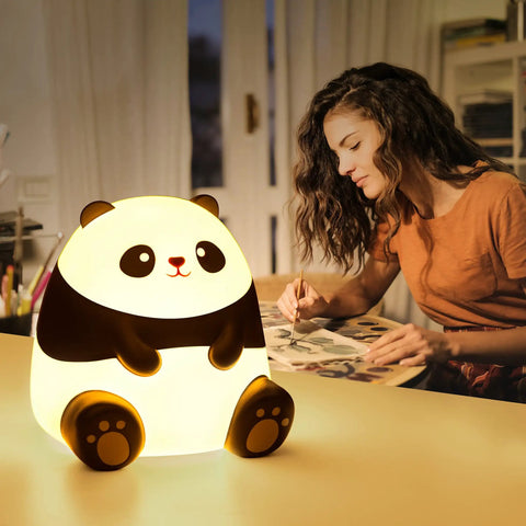 Woman painting beside Panda Night Light For Kids With Cozy LED Glow Timer Auto Shutoff Battery Operated Silicone Animal Night Light