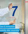 Person applying Clear Double Sided PET Film Tape With Acrylic Adhesive, 2 Inch Wide By 60 Yard Roll to a glass surface