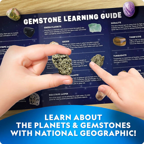 Child holding gemstone over learning guide from Space Gemstone Dig Kit For Kids With 8 Planet Shaped Bricks And 16 Real Gem And Mineral Specimens