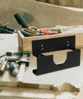 Black Iron Angle Grinder Holder Rack for garage and workshop wall mount tool organizer displayed on a wooden table