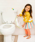 No Fuss Toddler Potty Training Seat With Rock Solid Non Slip Base Secure Handgrips And Quick Wipe Plastic Body For Smooth Potty Learning Journey In Bright Green held by girl near toilet.