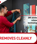Man using Clear Medium Wall Hooks Set, 12 Hooks With 24 Adhesive Strips, Each Holds Up To 2 Pounds, damage-free hanging on wall