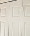 Rock Solid Bifold Door Lock Kit That Keeps Kiddos And Fur Babies Out Of Trouble While Blocking Finger Pinch Hazards Through A Slick Auto Click Design For Parents Dead Set On Creating Super Safe Family Habits Daily installed on white bifold doors.