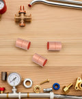 Premium Copper Coupling Fittings 0.59 Inch Straight Pipe Connectors on a wooden surface for HVAC and plumbing applications.