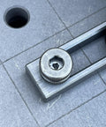 Close-up of heavy duty Hassle Free 5/8 Quick Release Ball Lock Pins for Modular Welding Fixture Tables on work surface.