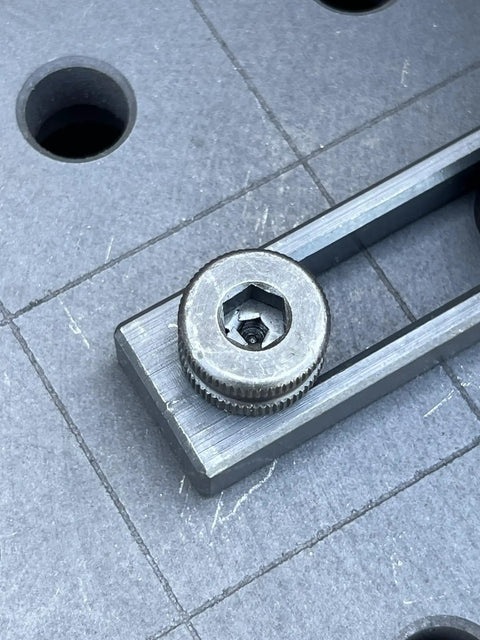 Close-up of heavy duty Hassle Free 5/8 Quick Release Ball Lock Pins for Modular Welding Fixture Tables on work surface.
