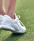Stellarlyte Women's Cheer Shoe White Size 8.5 for Competition on grass, showing back view with flexible outsole