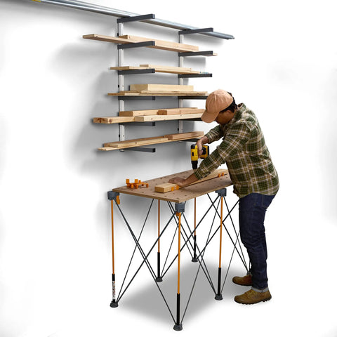 Worker using a drill next to a Six Level Wall Mounted Metal Lumber Rack For Garage Organization And Heavy Duty Wood Storage Shelf Pipe Holder Plywood Sheet Stand Optimizing Your Workspace In A Flash.