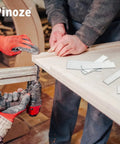 Worker using a pneumatic nail gun with Straight Shooter 18 Gauge Brad Nails Assorted 1300 Count Galvanized Steel for woodworking.