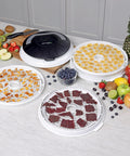 Electric Food Dehydrator With Four Stackable Trays And Top Mounted Fan displaying dried fruits, beef jerky, and fresh produce.